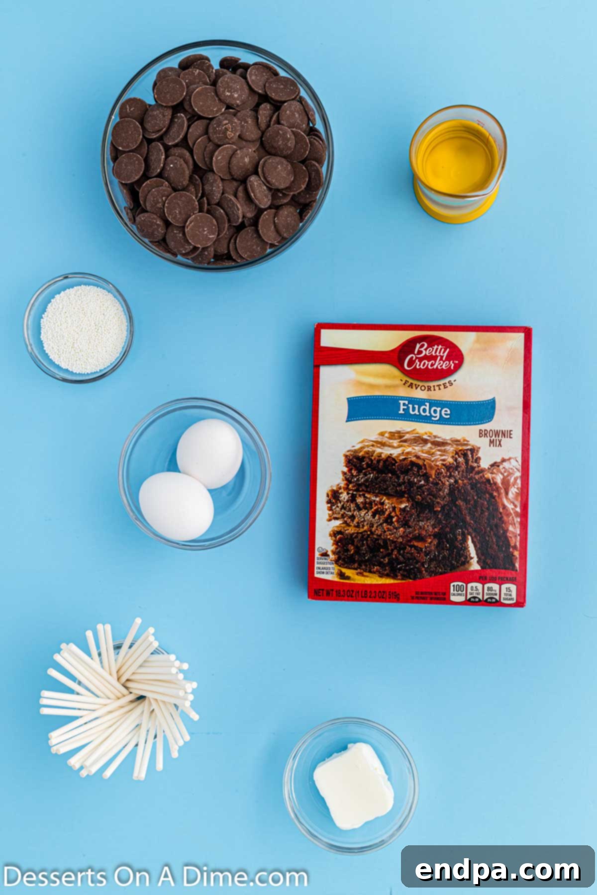 Ingredients for Brownie cake pops. - brownie mix, cake pop sticks, candy melts, shortening, white sprinkles. 