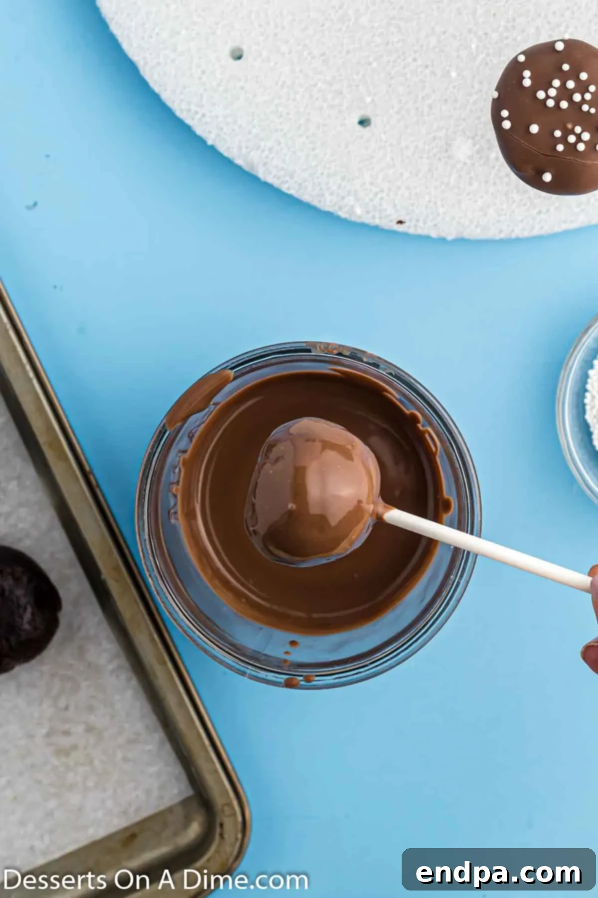 Cake pop dipped and excess chocolate removed. 