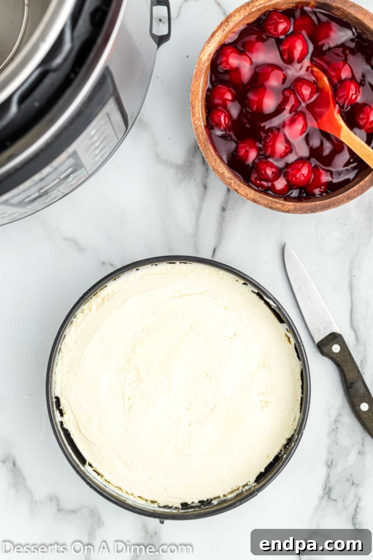 A perfectly cooked cheesecake cooling on a wire rack after being removed from the Instant Pot.