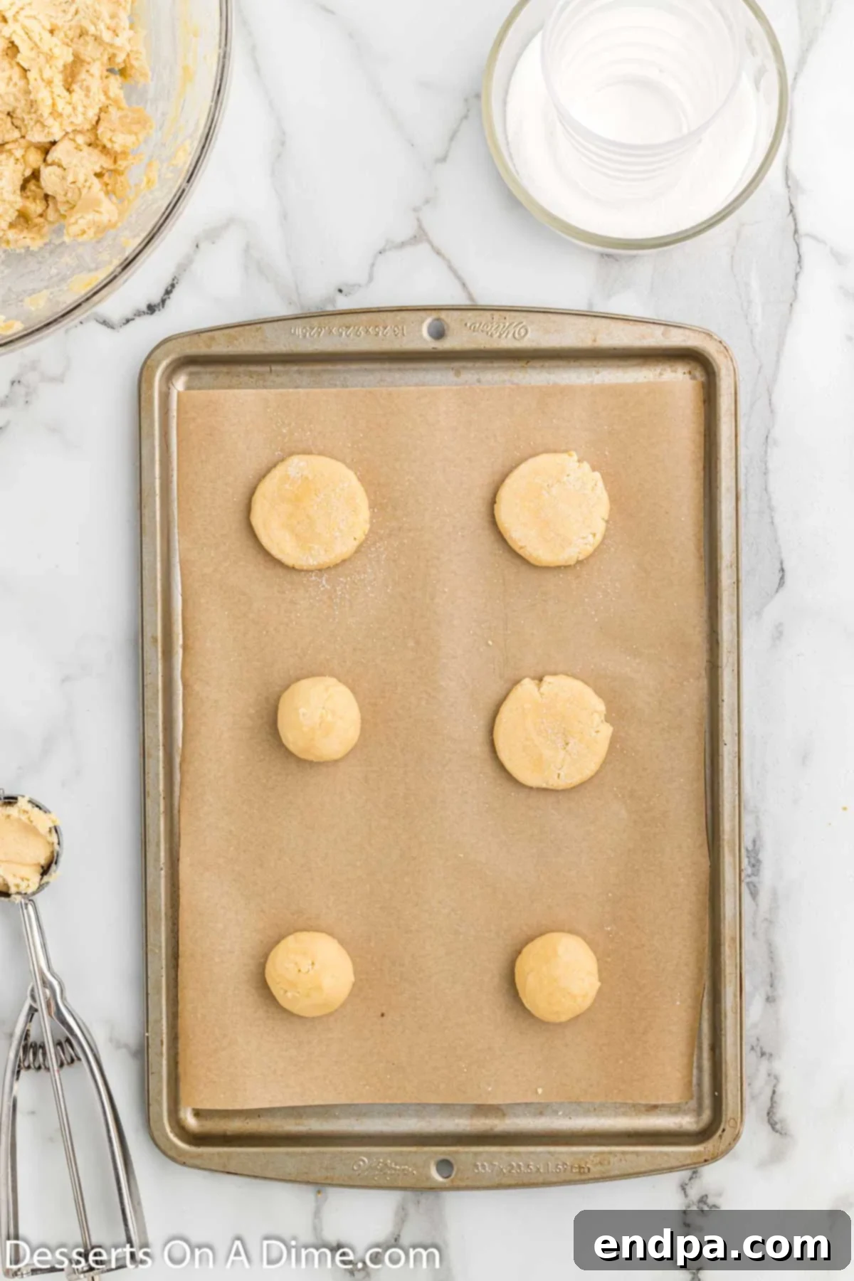 Classic Comfort Sugar Cookies 5 Cookie dough balls on baking sheet.
