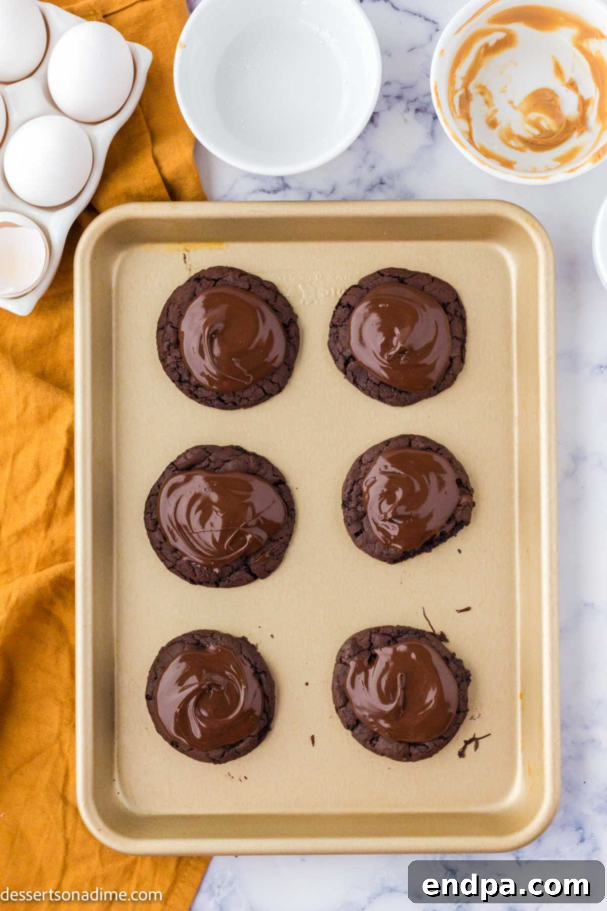 Ultimate Buckeye Brownie Delights 11 Finished Buckeye Brownie Cookies, each with a smooth layer of melted chocolate covering the peanut butter center.