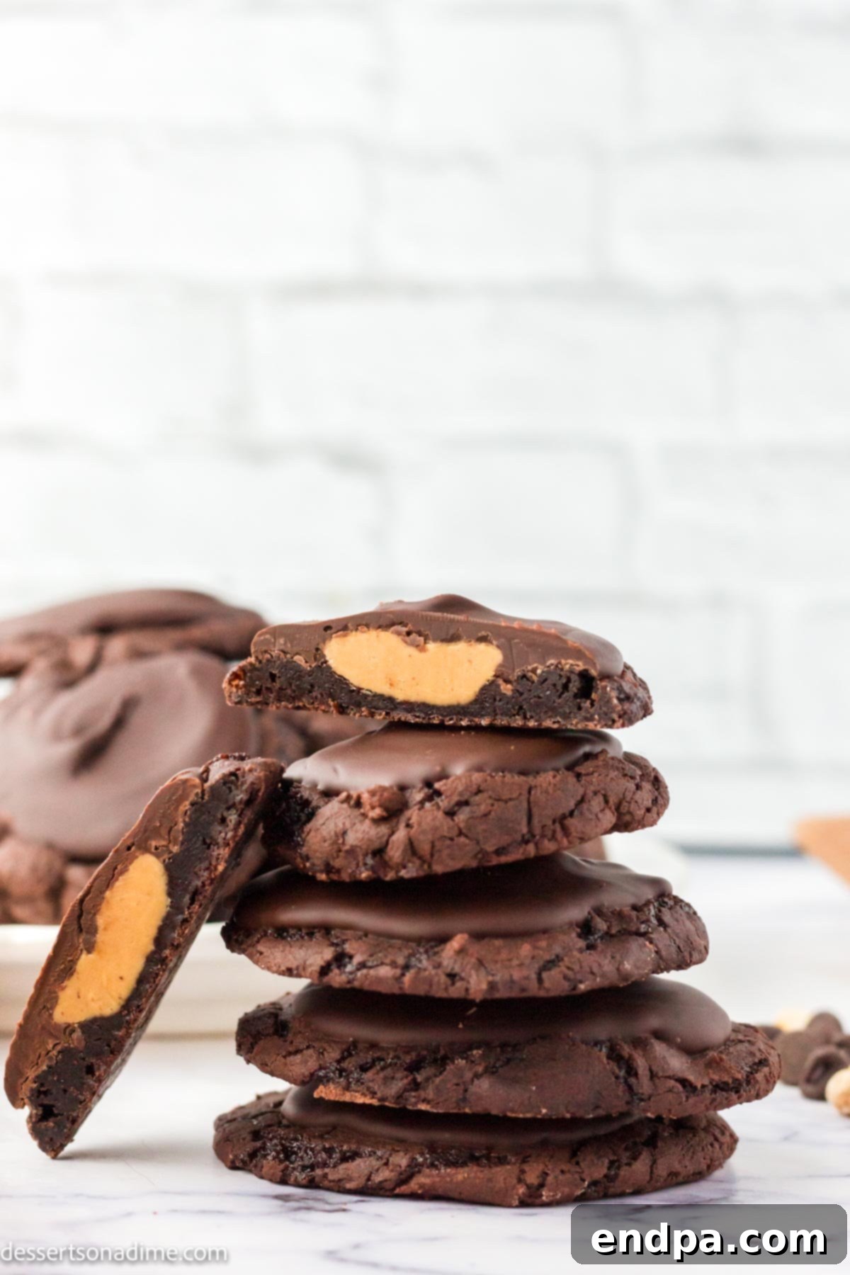 Ultimate Buckeye Brownie Delights 12 A stack of perfectly crafted Buckeye Brownie Cookies, showing the distinct layers of chocolate cookie, peanut butter, and chocolate topping.