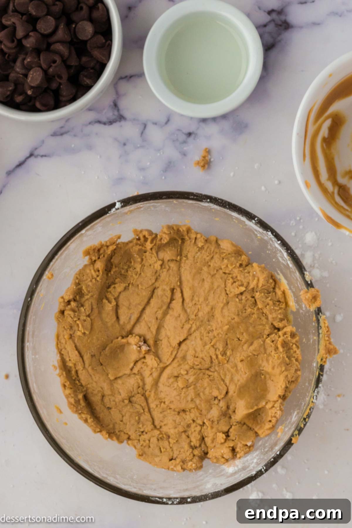 Ultimate Buckeye Brownie Delights 7 The peanut butter dough, rolled into small, uniform balls, resting in a bowl.