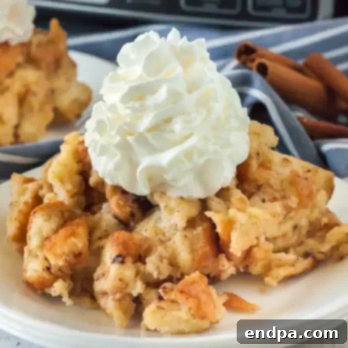 Warm Crock Pot Bread Pudding, rich with cinnamon and served in a ceramic dish.