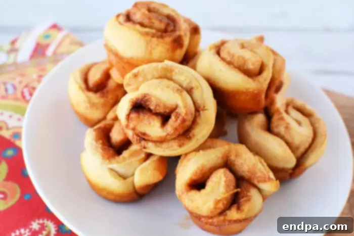 Plate of Super Easy Mini Cinnamon Rolls, warm and glazed.