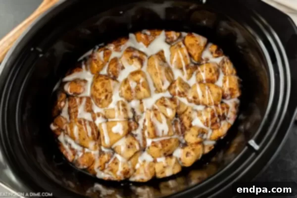 Crock Pot Cinnamon Roll Casserole, gooey and ready to serve from the slow cooker.
