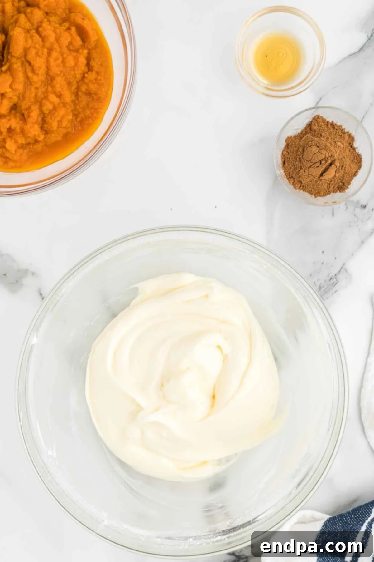 The smooth, combined cream cheese and powdered sugar mixture, light and ready for the remaining pumpkin dip ingredients.