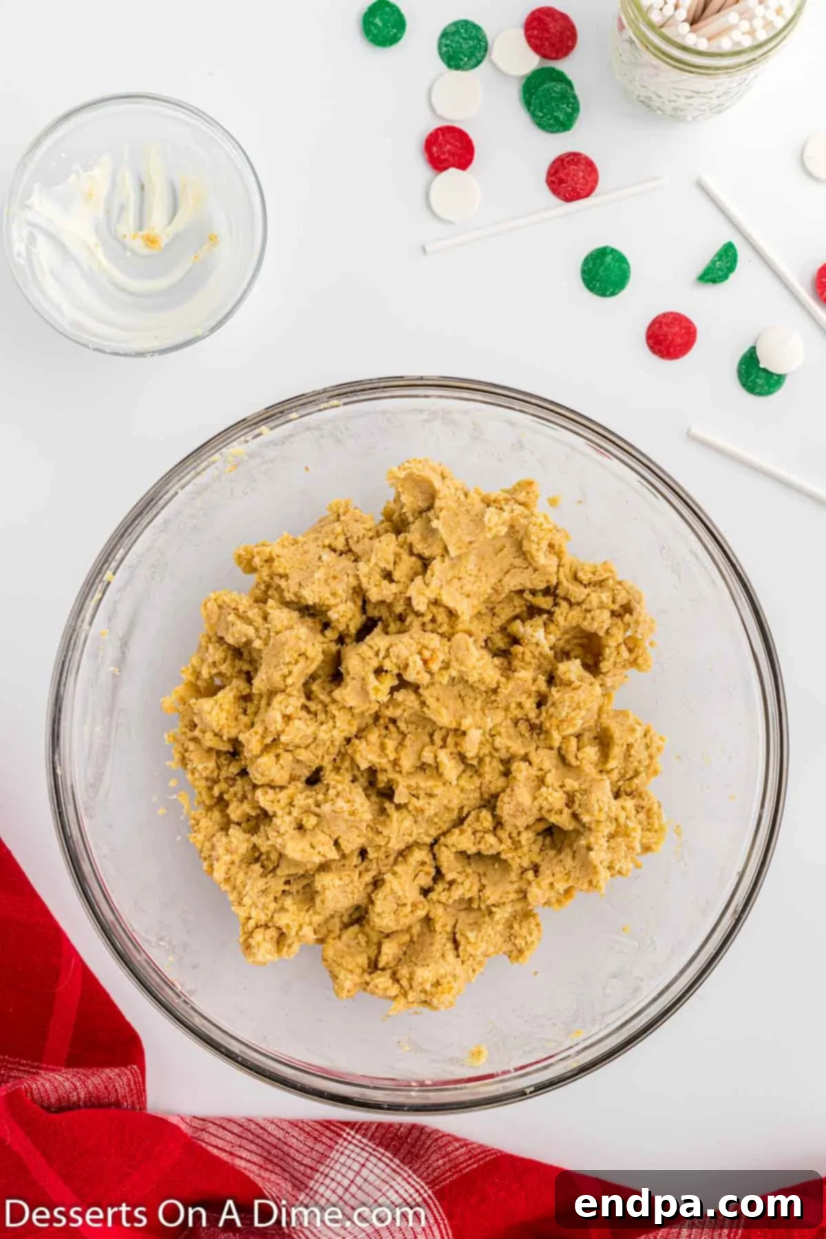 Cake crumbles mixed with cream cheese frosting in a bowl.