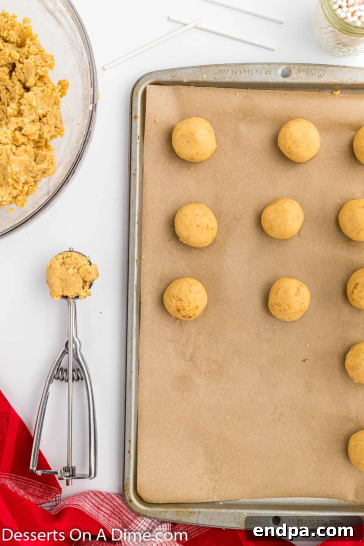 Cake mixture formed into uniform balls and placed on a baking sheet lined with parchment paper.