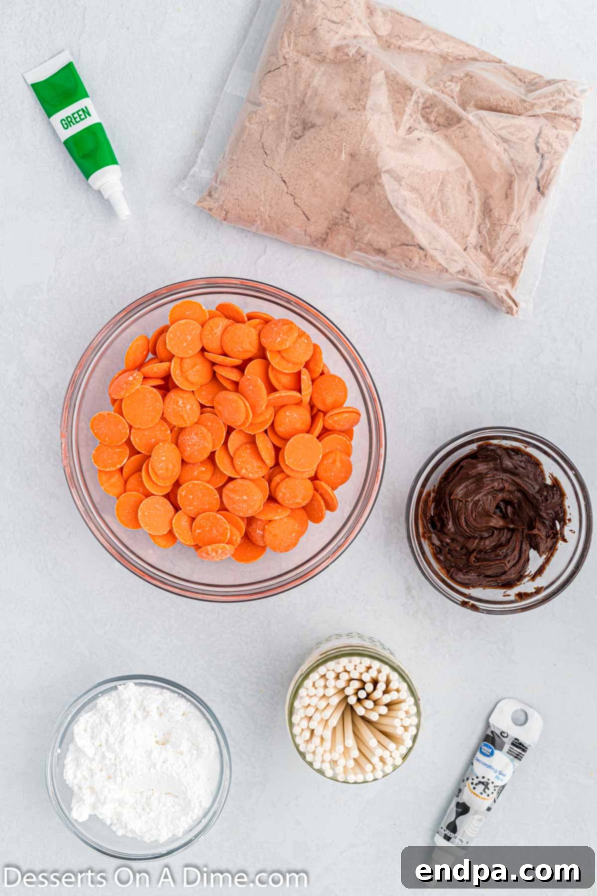 Spooky Sweet Halloween Cake Pops 3 Ingredients for Halloween cake pops including chocolate box cake mix, chocolate frosting, orange candy melts, powdered sugar, green food gel coloring, black gel icing, and lollipop sticks.