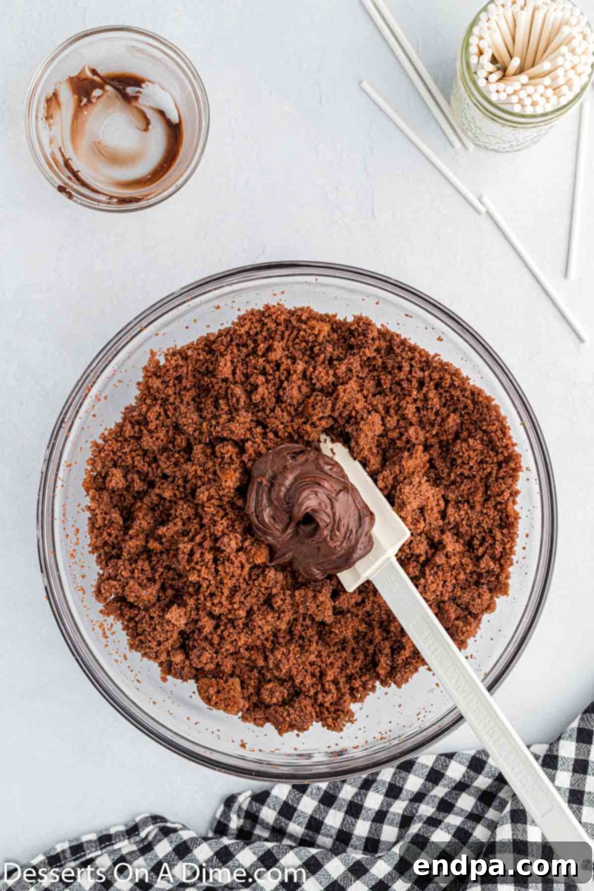 Spooky Sweet Halloween Cake Pops 5 Crumbling cooled cake into a large bowl and mixing with chocolate frosting.