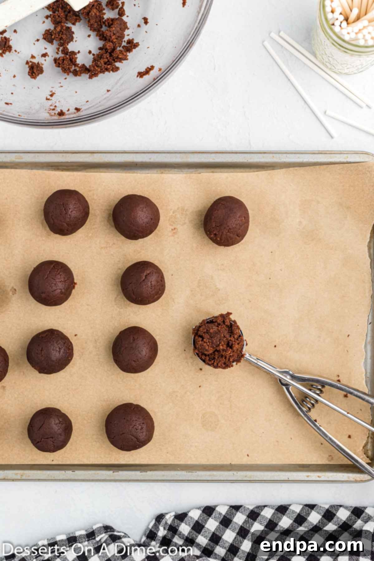 Spooky Sweet Halloween Cake Pops 6 Rolling cake mixture into uniform balls and placing them on a baking sheet lined with parchment paper.