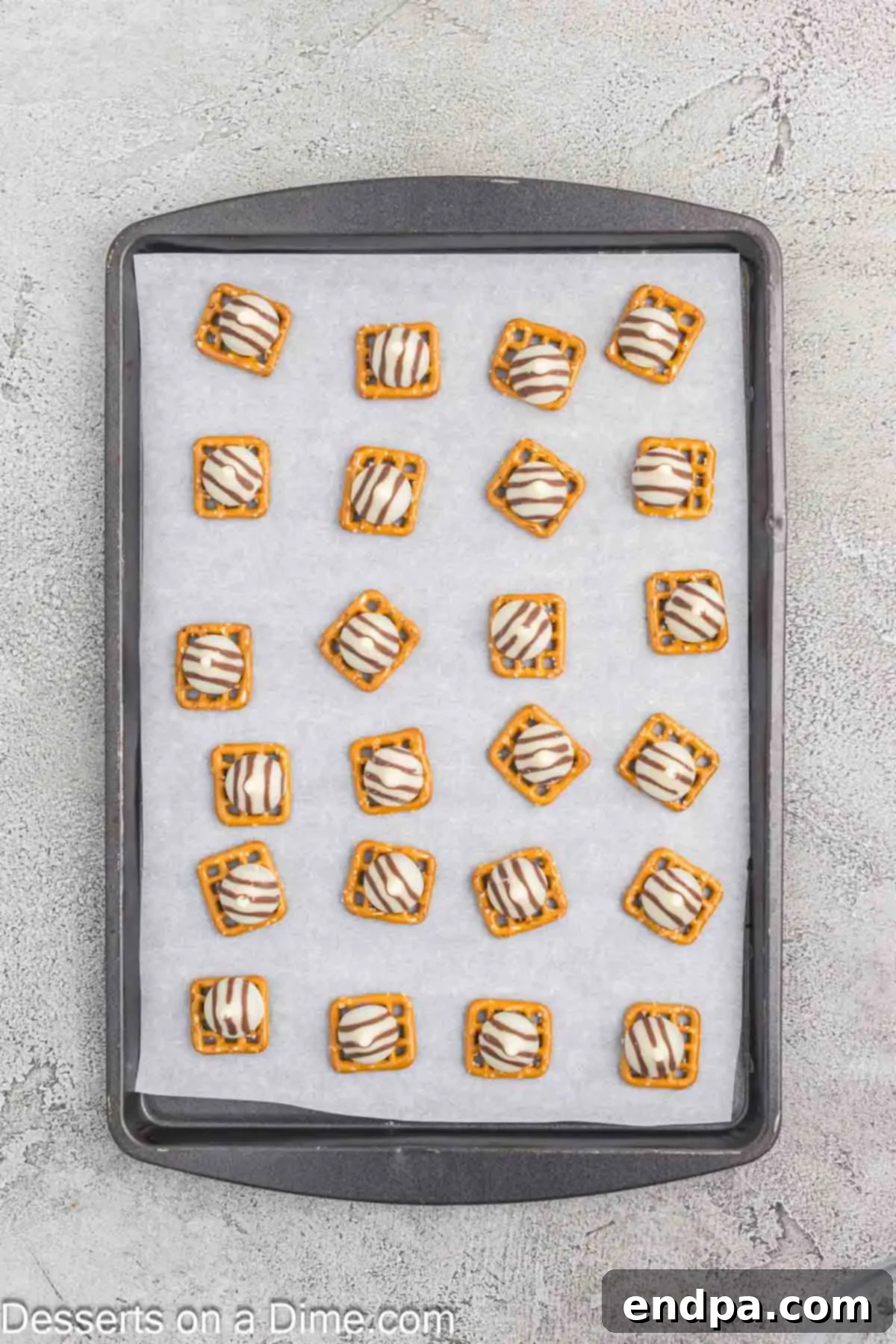 Hershey Hugs candies placed on top of each pretzel square.
