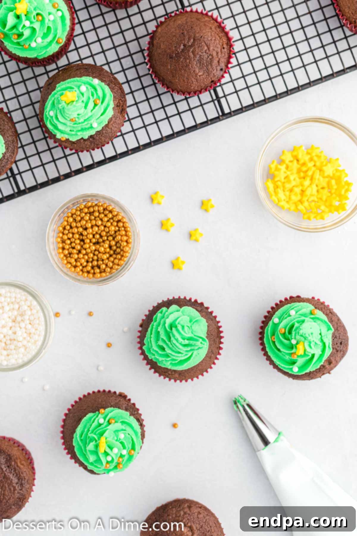The piped green frosting on top of each cupcake, adorned with colorful candy balls and a yellow sugar star, giving them a complete Christmas tree look.