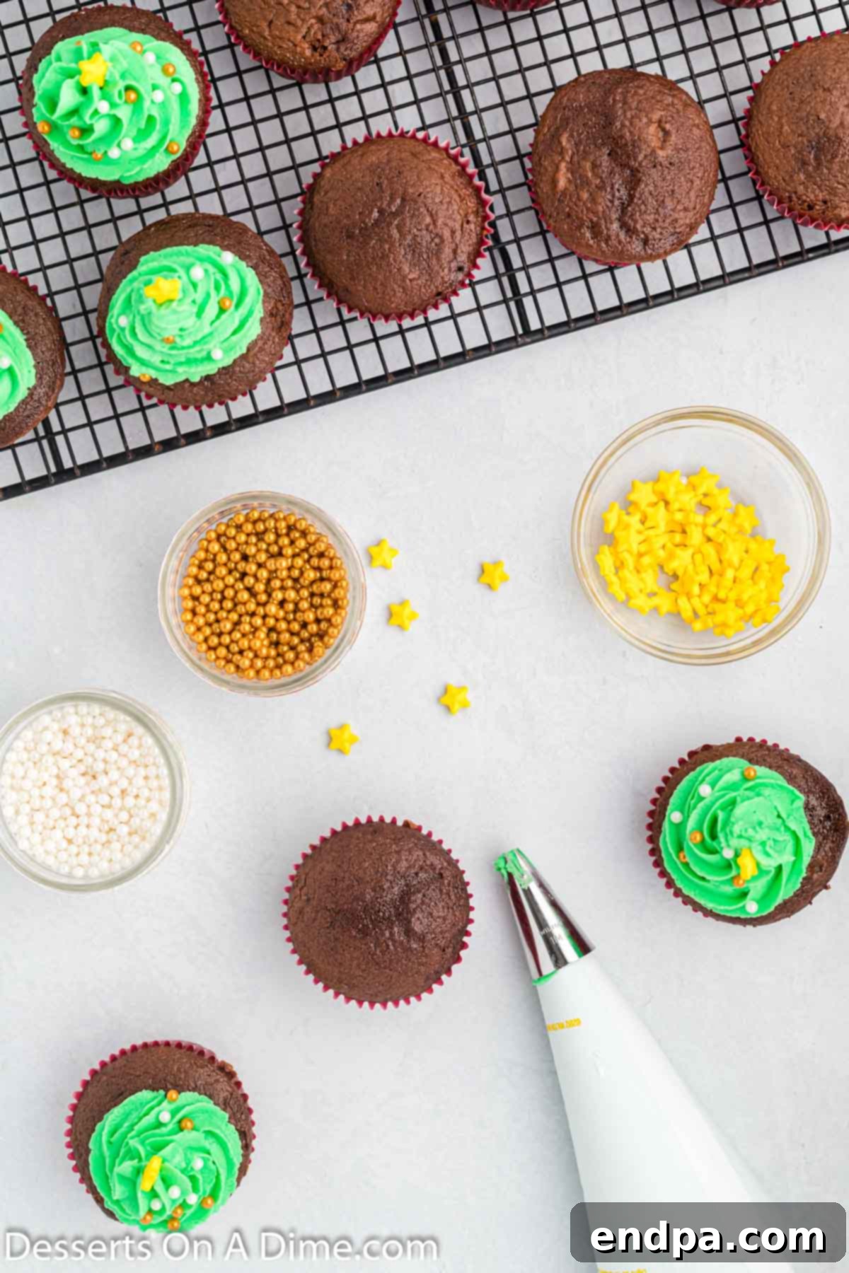 Decorated Christmas tree cupcakes, ready for serving, showing the piped green frosting, candy ornaments, and a yellow star on top.