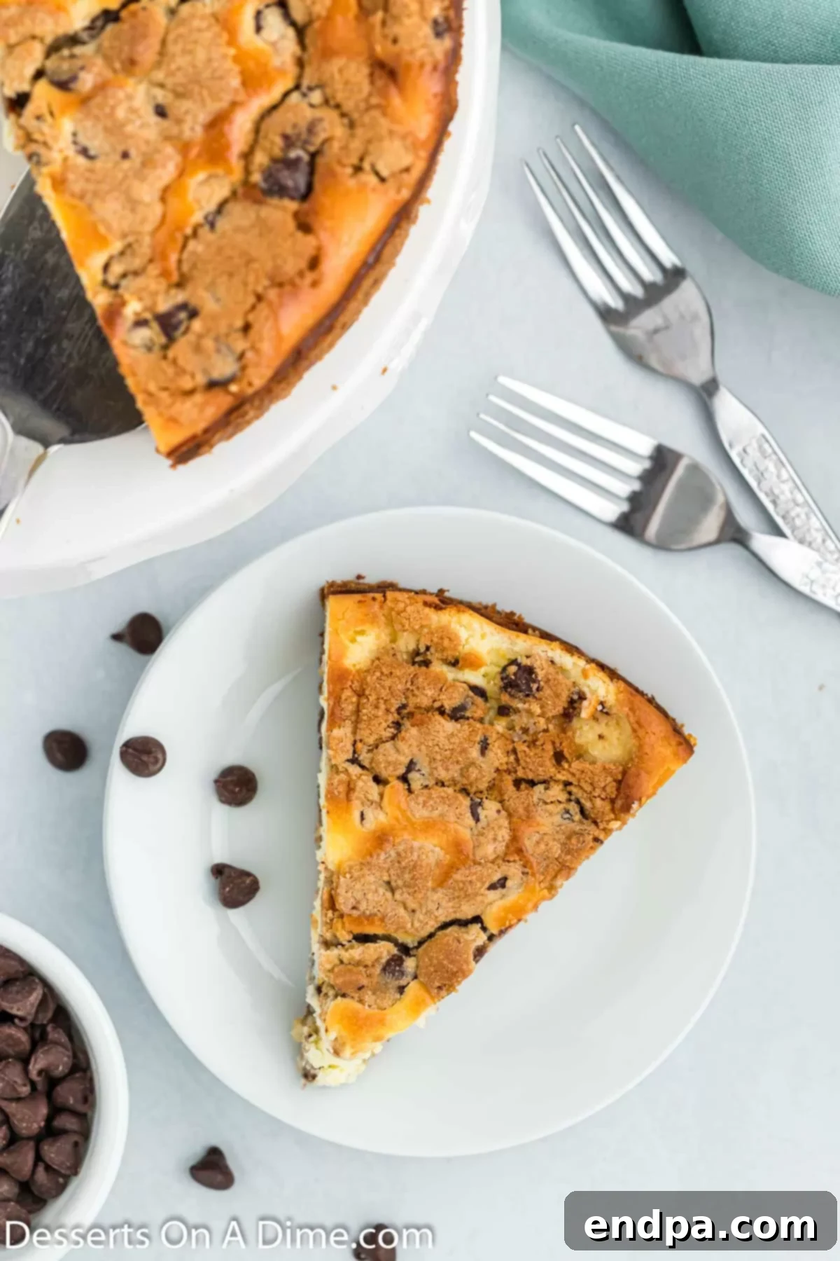 Cookie Dough Dream Cheesecake 8 A vibrant, close-up shot of a single slice of Chocolate Chip Cookie Cheesecake on a white plate, showcasing its appealing layers and rich texture.