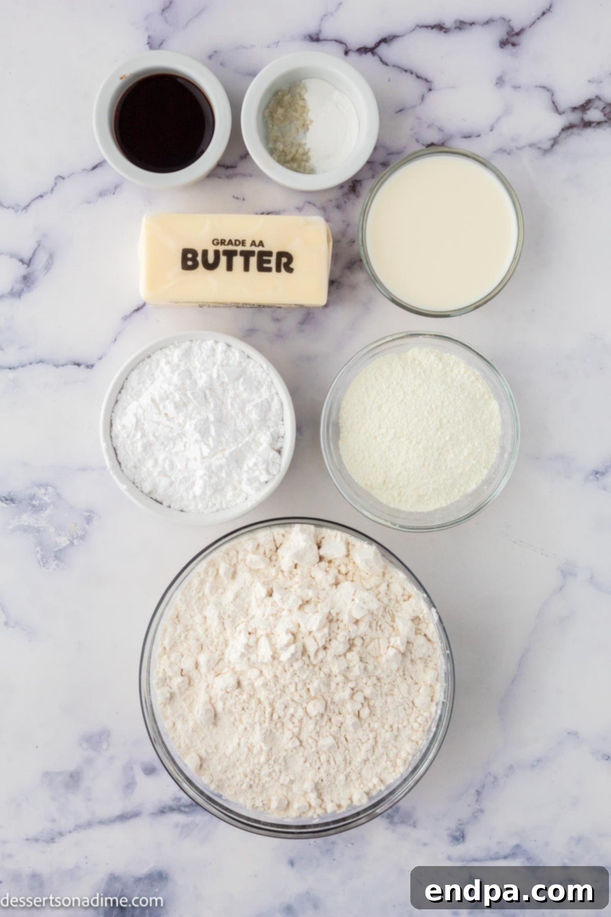 Ingredients laid out for custard cookies: flour, custard powder, butter, powdered sugar, vanilla extract, and milk.