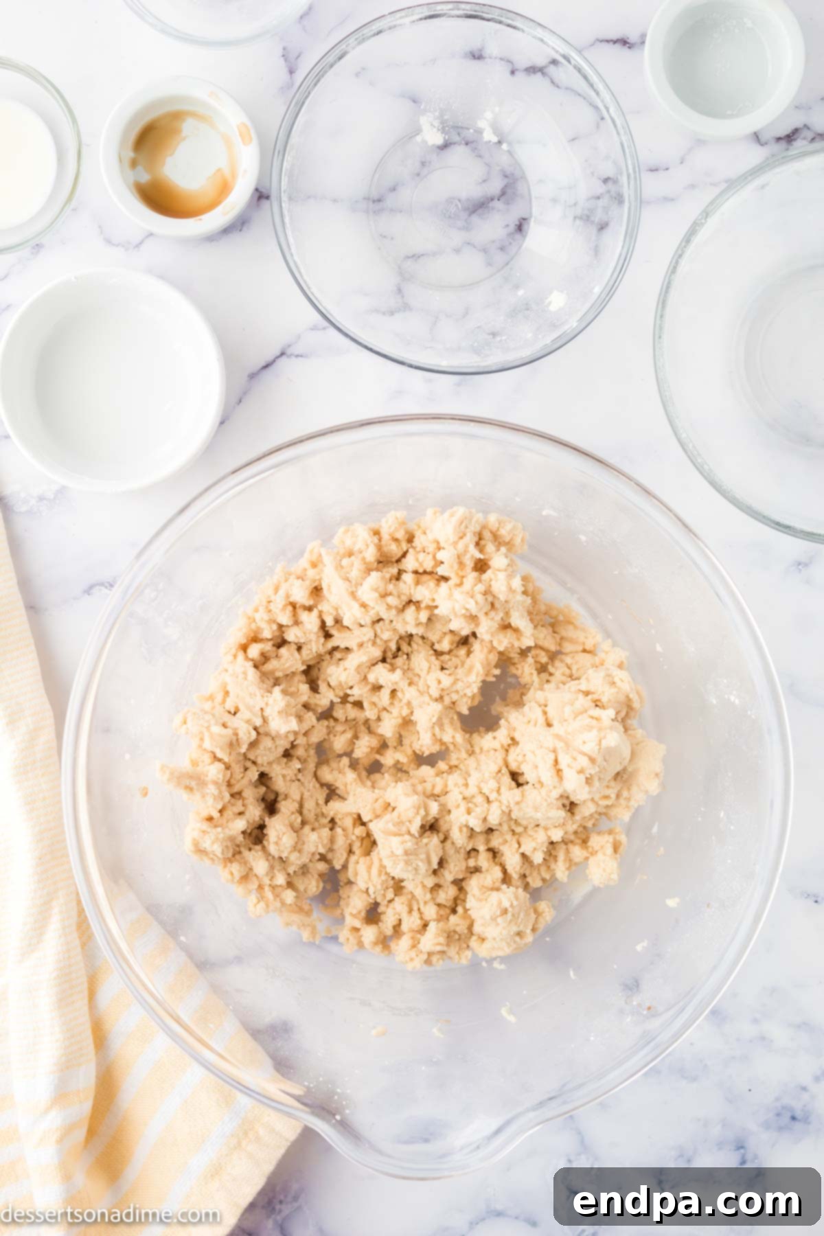 Wet and dry ingredients combined in a bowl to make cookie dough.