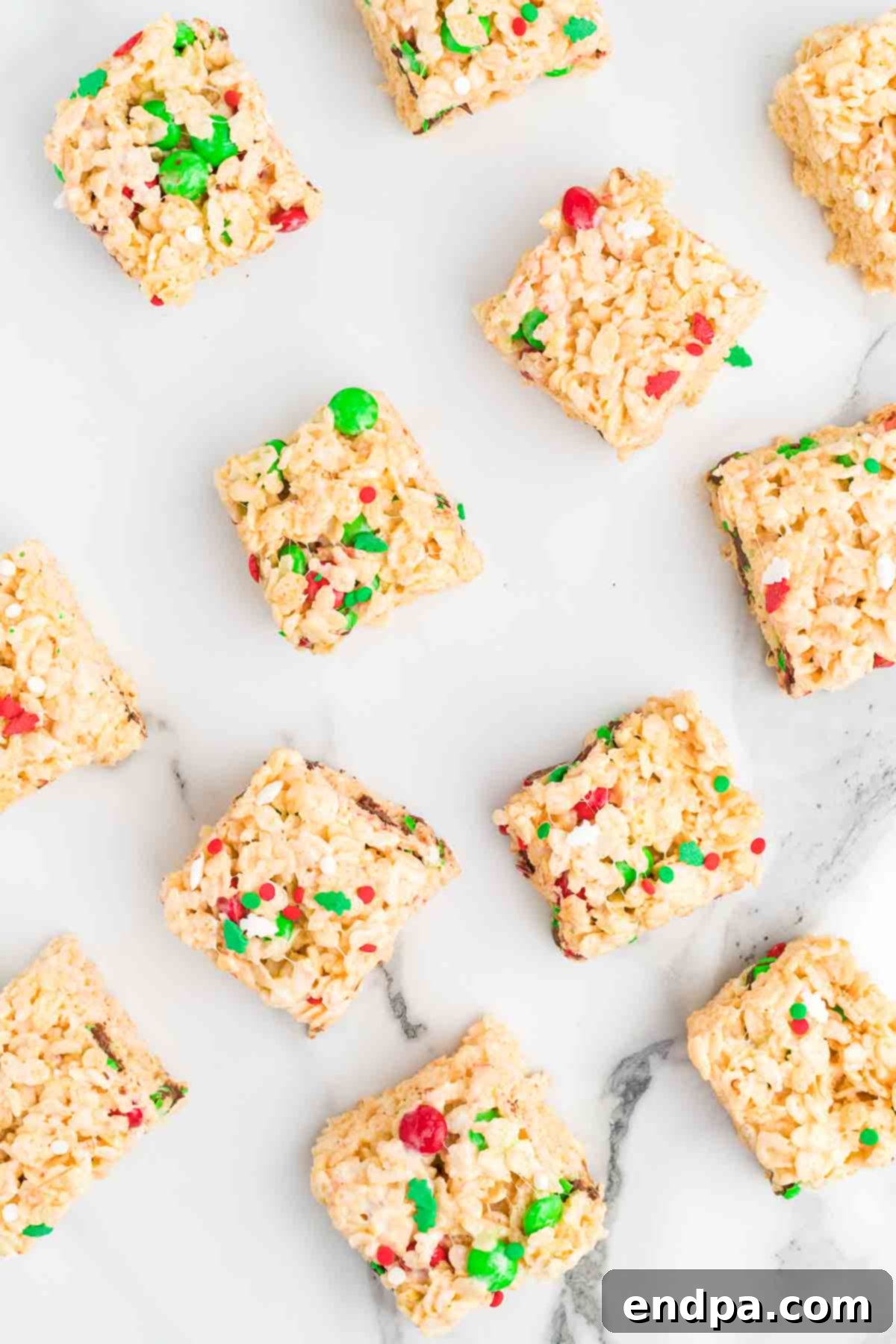 Jolly Krispie Delights 10 Finished Christmas Rice Krispie Treats, perfectly cut into squares and showcasing their vibrant holiday colors and chewy texture.