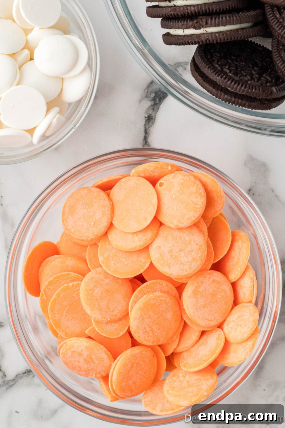 Orange candy melts in a bowl, waiting to be melted.