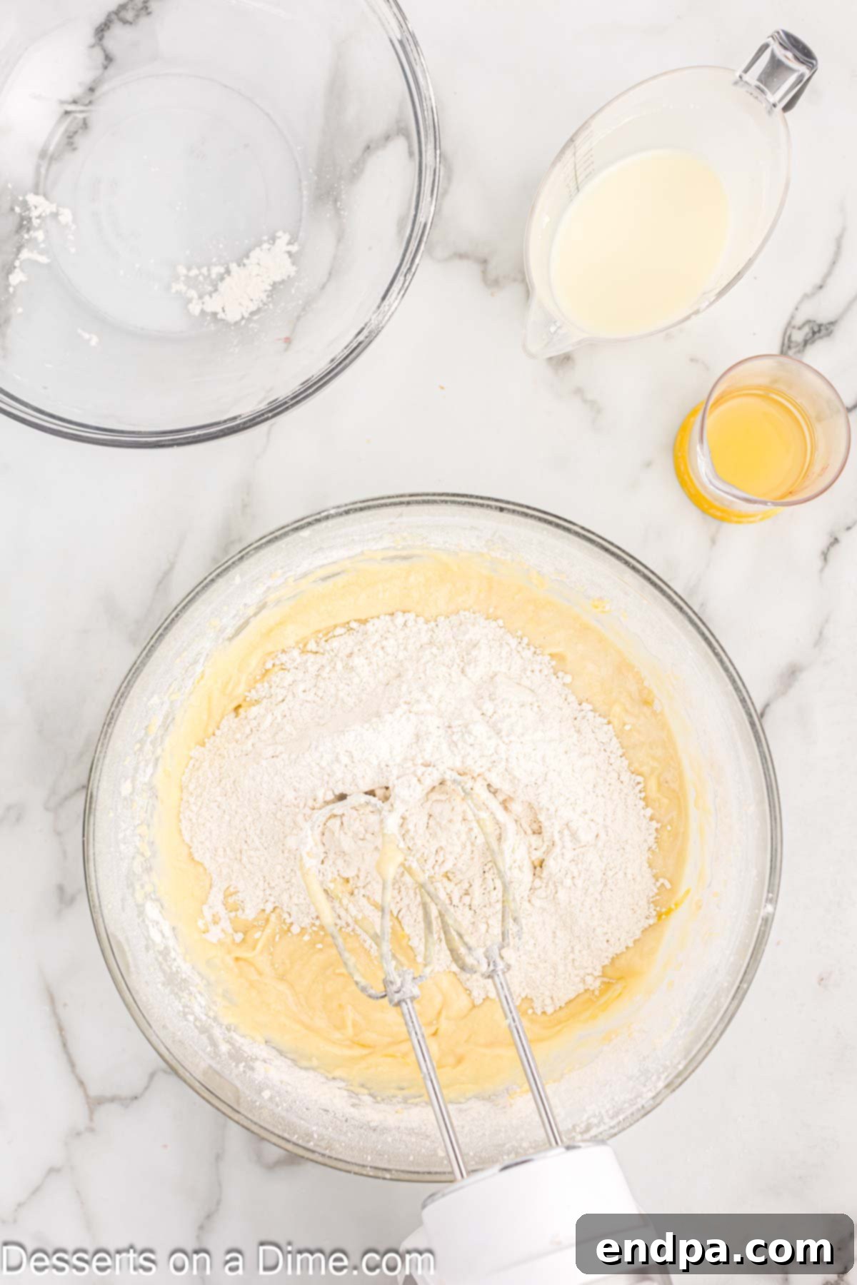 Wet and dry ingredients combined in a mixing bowl for the cupcake batter.
