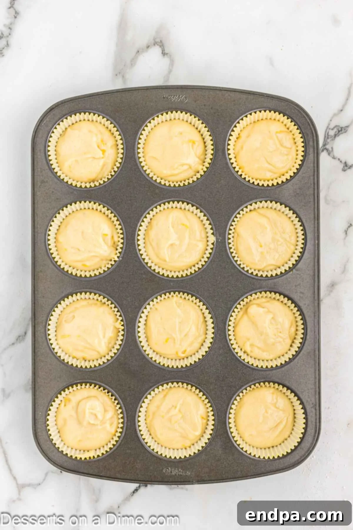 Cupcake batter poured into muffin tin liners.