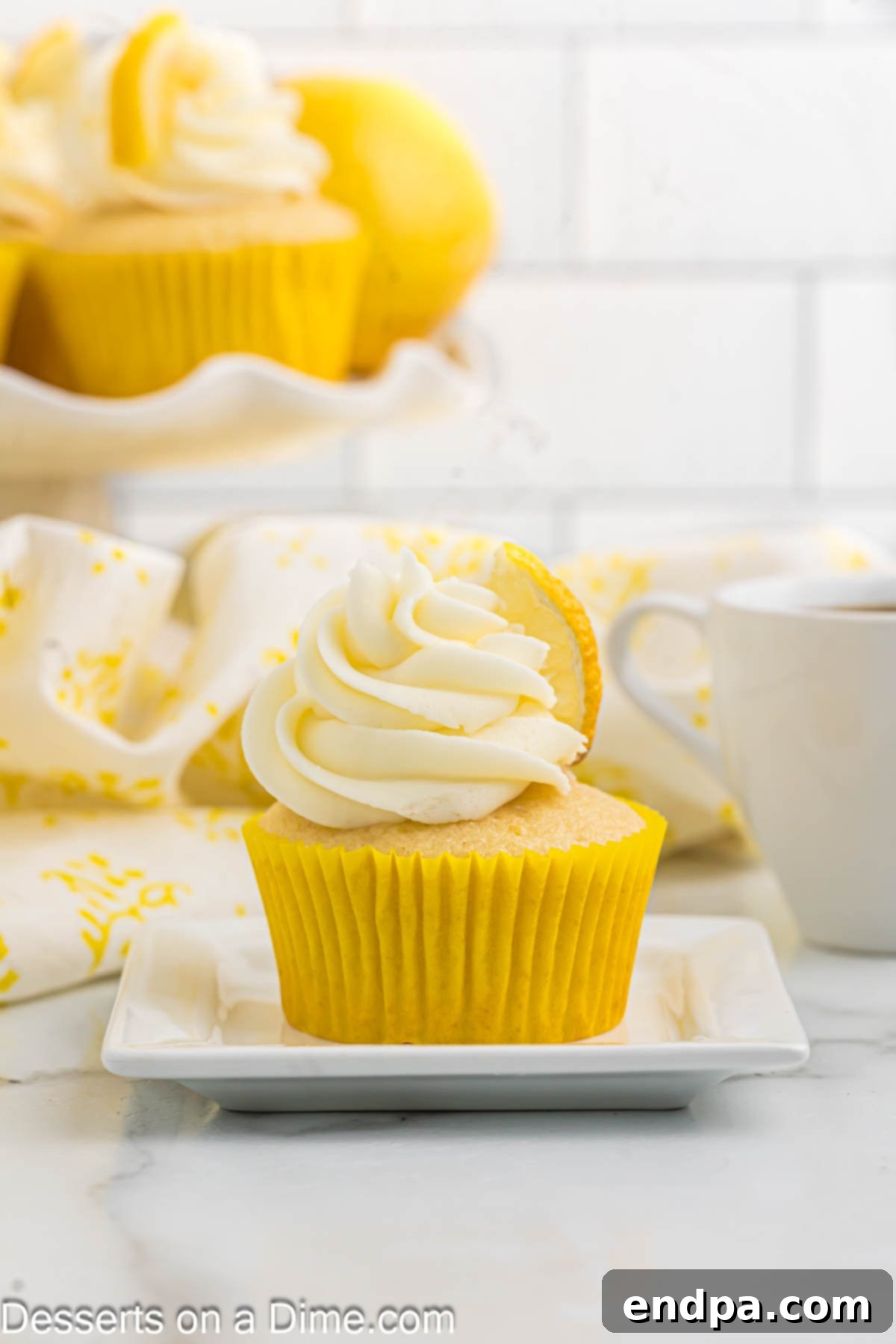 A frosted lemon cupcake topped with a lemon slice.