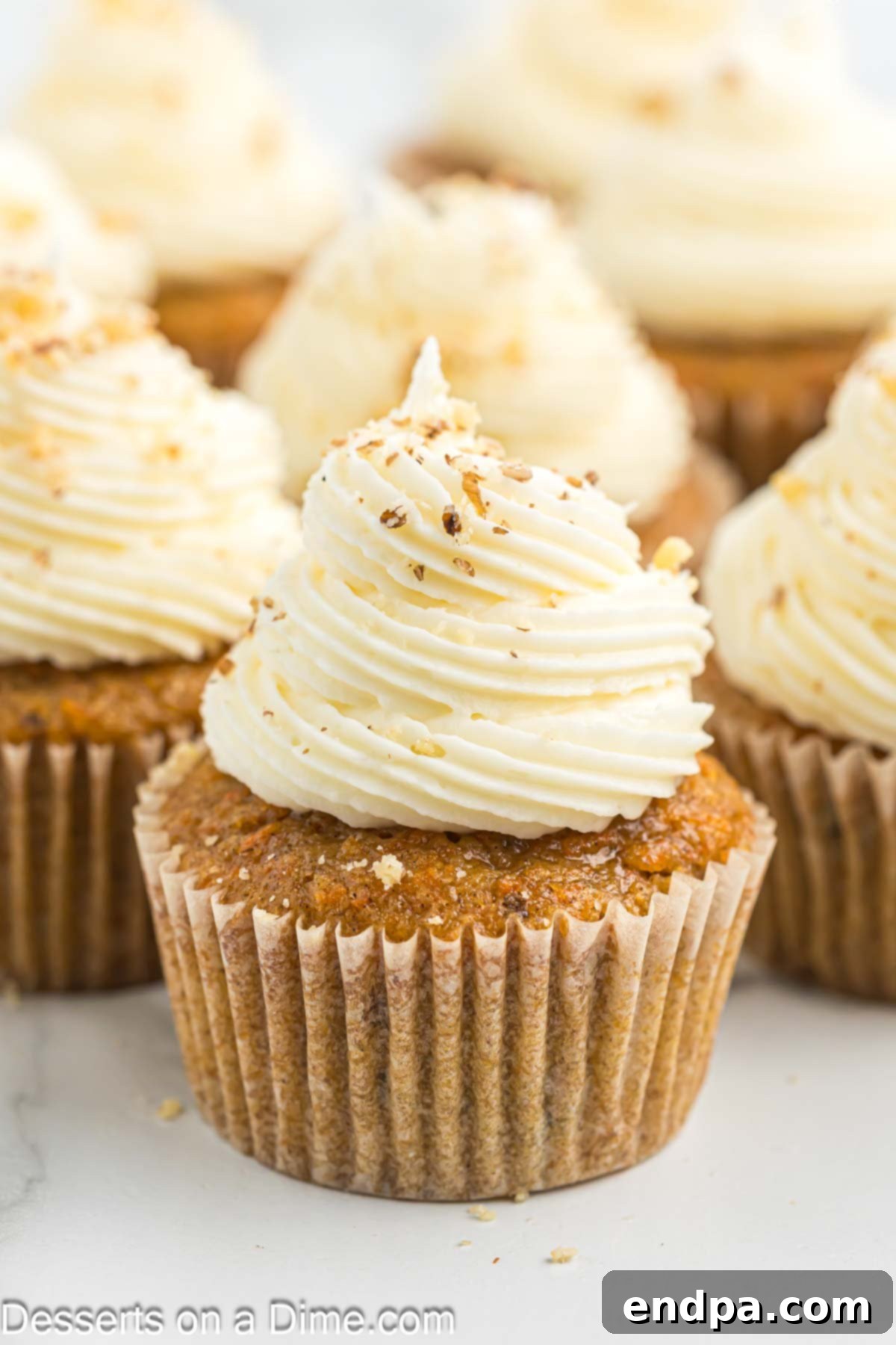 Irresistible Carrot Cake Cupcakes 11 Cream cheese and butter being beaten together in a mixing bowl for frosting.