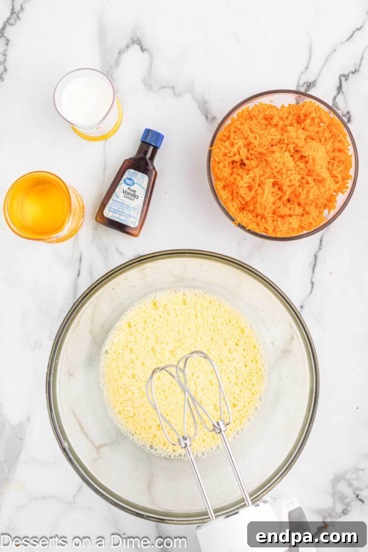 Irresistible Carrot Cake Cupcakes 5 Dry ingredients for carrot cake cupcakes being whisked in a large bowl.