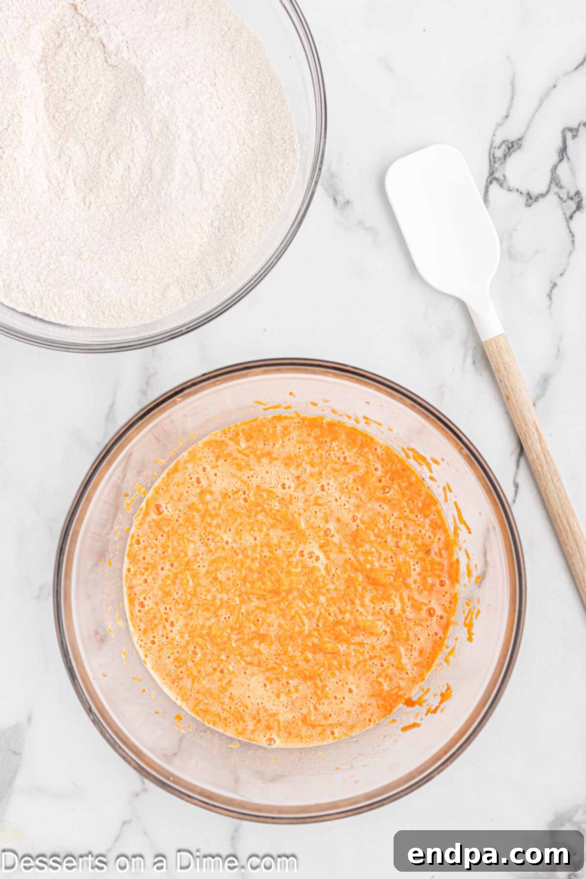 Irresistible Carrot Cake Cupcakes 6 Wet ingredients for carrot cake cupcakes, including beaten eggs, oil, buttermilk, vanilla, and shredded carrots, in a bowl.