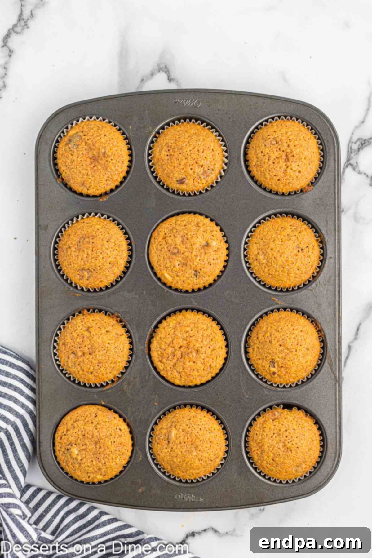 Irresistible Carrot Cake Cupcakes 9 Cupcake liners filled with carrot cake batter, approximately three-quarters full.