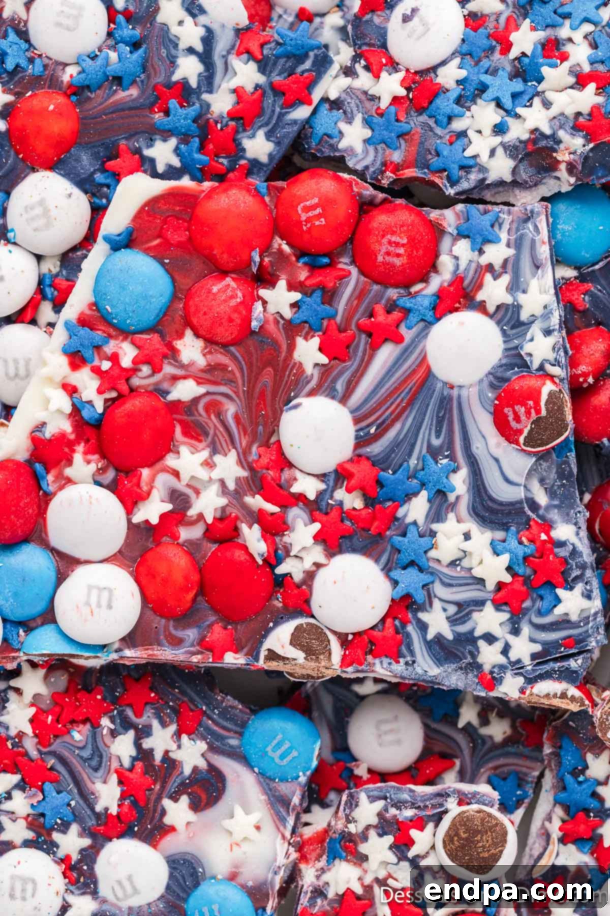 Patriotic Bark broken into pieces, showcasing red, white, and blue layers with sprinkles.