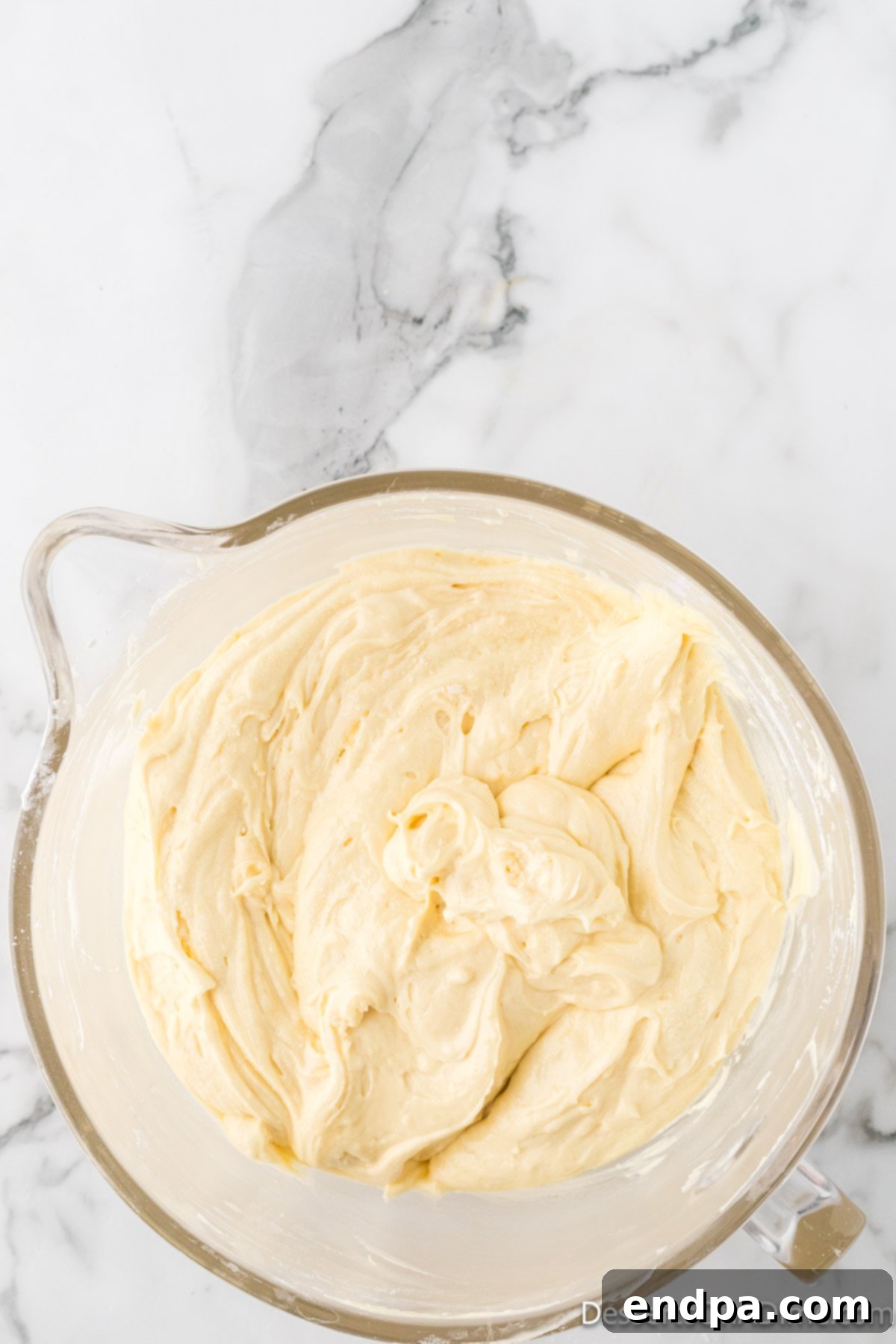 Dreamy Cream Cheese Pound Cake 12 The completed pound cake batter, perfectly combined in a bowl, displays a smooth and consistent texture, ready to be poured into the baking pan.