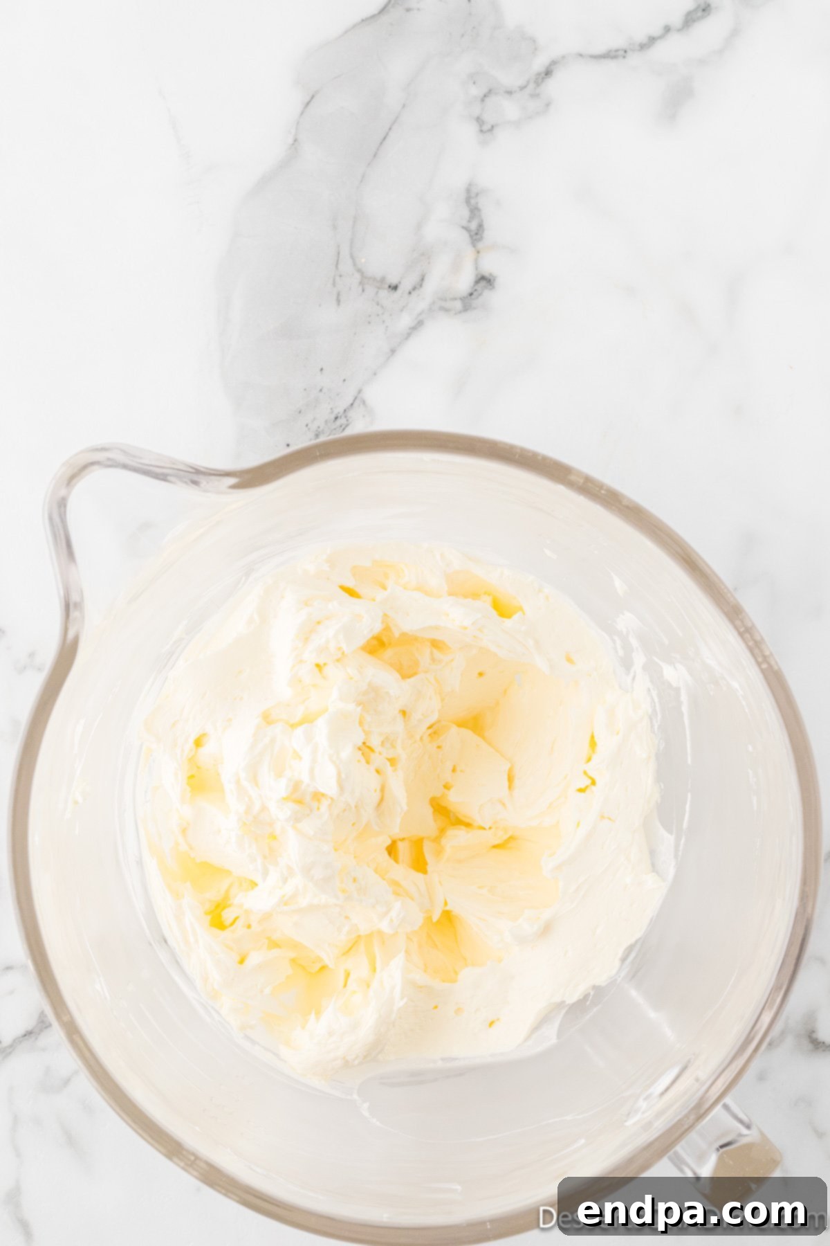 Dreamy Cream Cheese Pound Cake 4 A mixing bowl containing softened cream cheese and butter, perfectly combined to a smooth consistency, ready for the next step in the pound cake recipe.