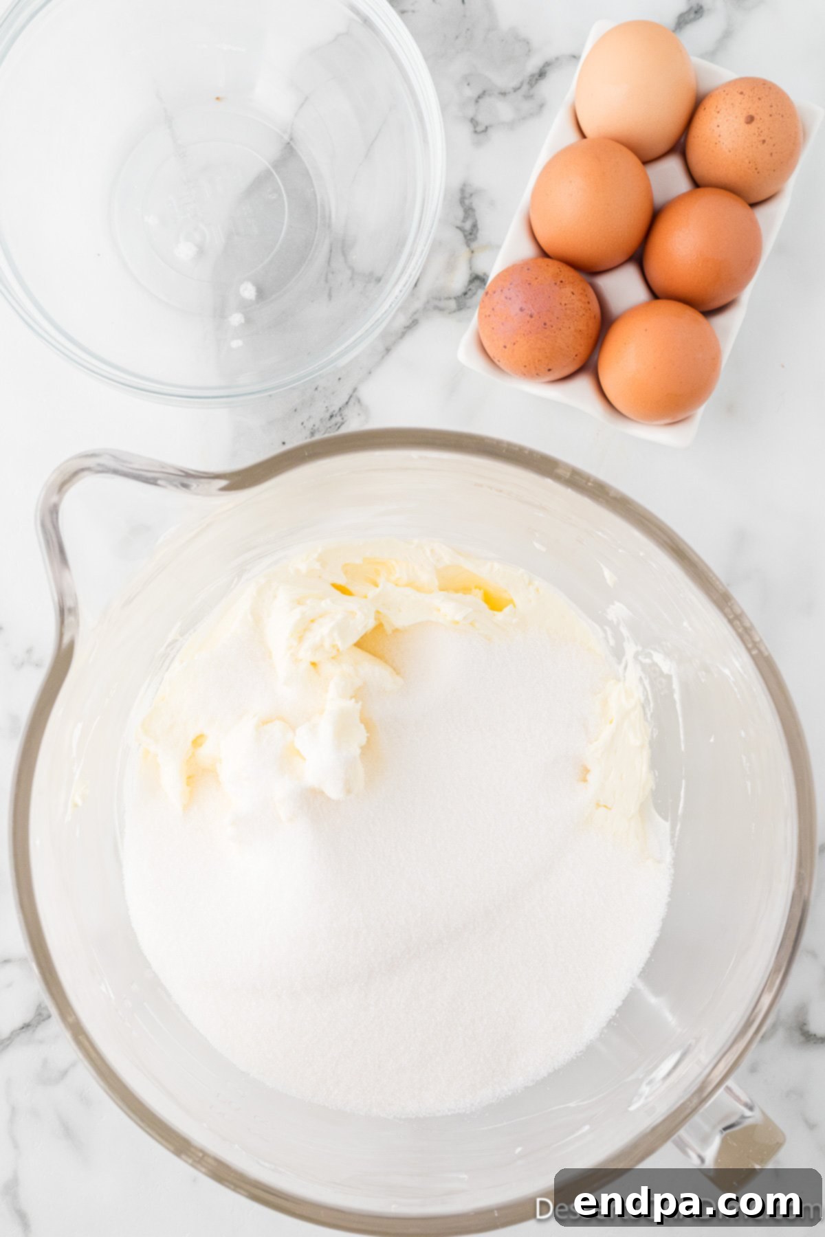Dreamy Cream Cheese Pound Cake 7 Granulated sugar is added to the creamy butter and cream cheese mixture in the mixing bowl, ready to be beaten until light and fluffy.