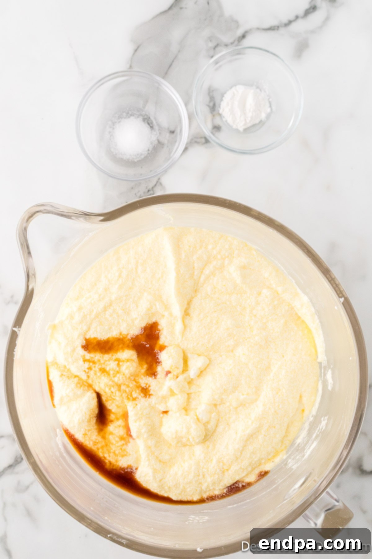 Dreamy Cream Cheese Pound Cake 10 Vanilla extract, baking powder, and salt are gently mixed into the pound cake batter, distributing flavor and leavening agents evenly.