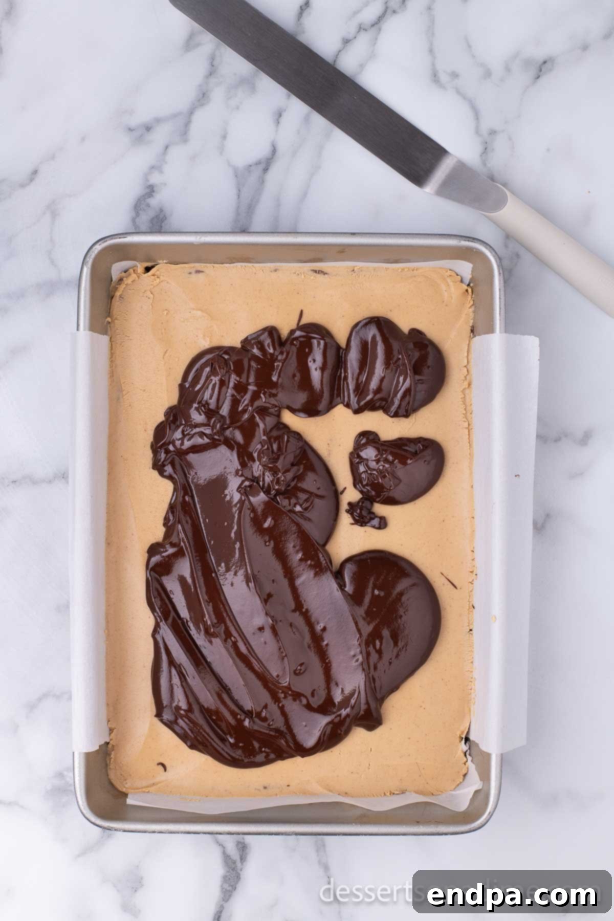 Decadent Chocolate Peanut Butter Buckeye Brownies 12 Chocolate spread on peanut butter layer.