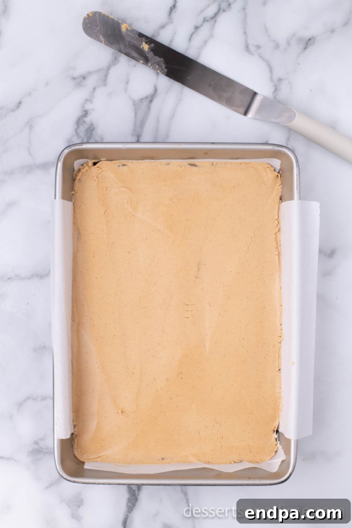 Decadent Chocolate Peanut Butter Buckeye Brownies 9 peanut butter spread on top of brownies.