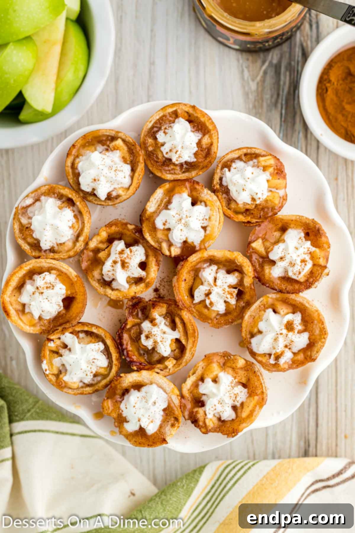 A stunning arrangement of Mini Apple Pie Bites on a crisp white platter, highlighting their perfect, golden crusts.