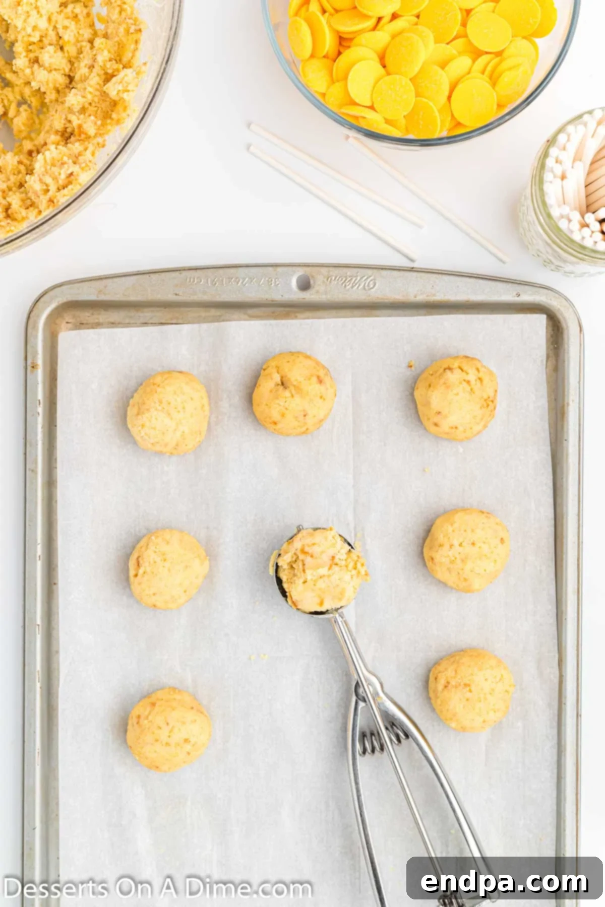 Copycat Starbucks Lemon Cake Pop Recipe 6 Cake balls scooped and placed on a baking sheet.