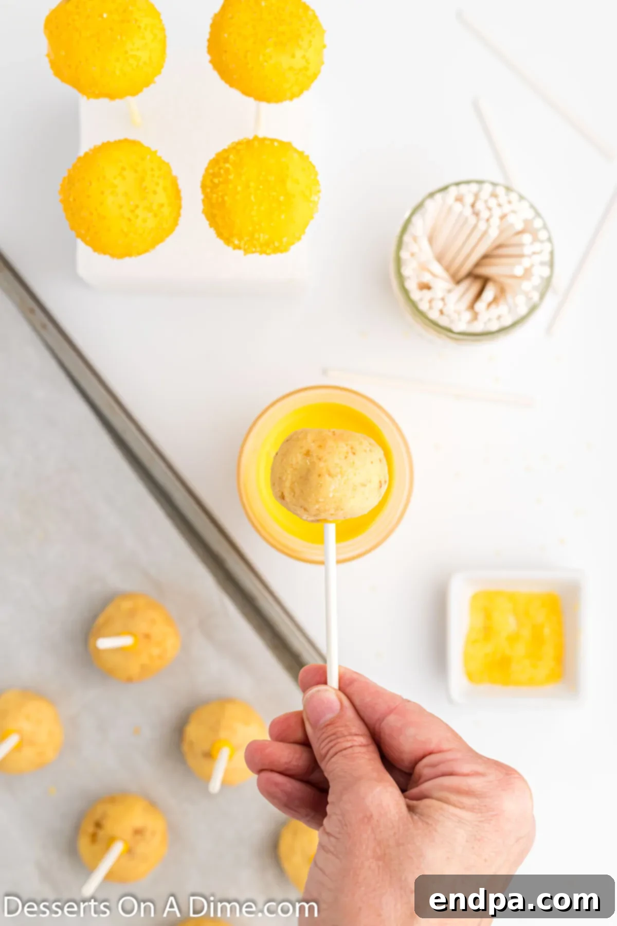 Copycat Starbucks Lemon Cake Pop Recipe 7 Cake pop sticks dipped into melted candy melts and inserted into cake ball.