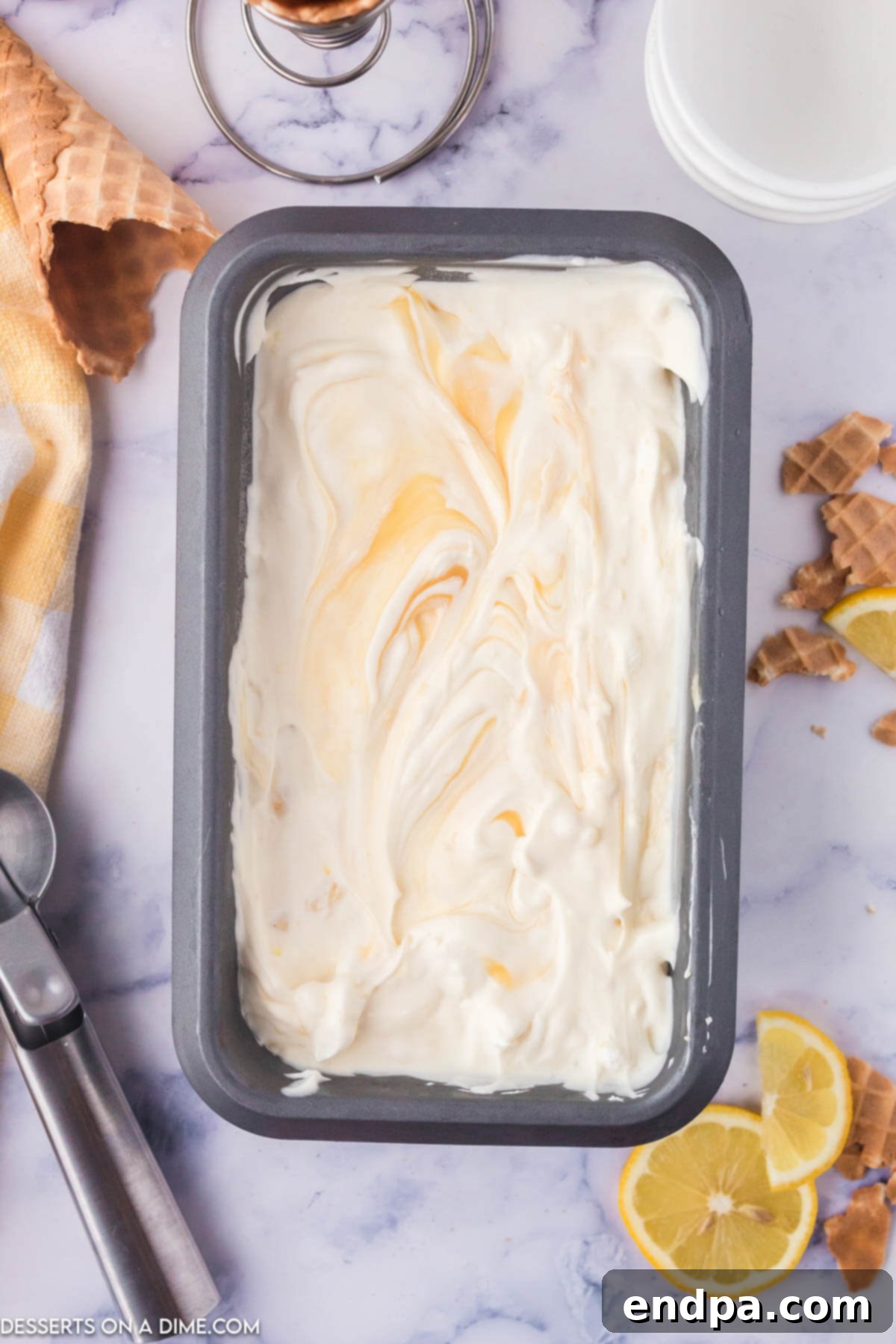 Zesty Shortbread Crumble Ice Cream 8 A container of creamy Lemon Shortbread Ice Cream, garnished with fresh mint.