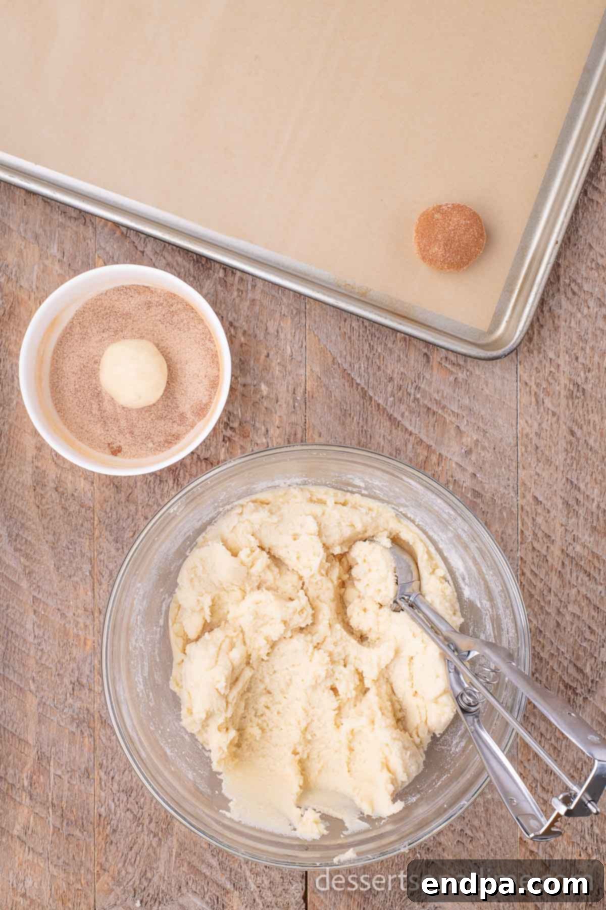 Simple Snickerdoodle Perfection 6 Bowl of cookie dough with a cookie scoop, and a separate bowl with cinnamon sugar mixture.