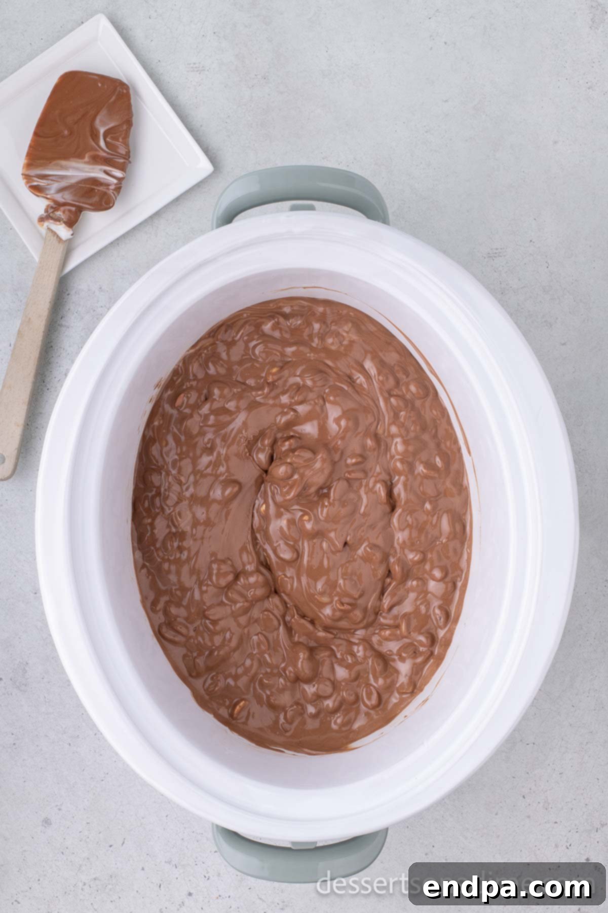 Melted chocolate and peanut mixture ready to be scooped from the crock pot.