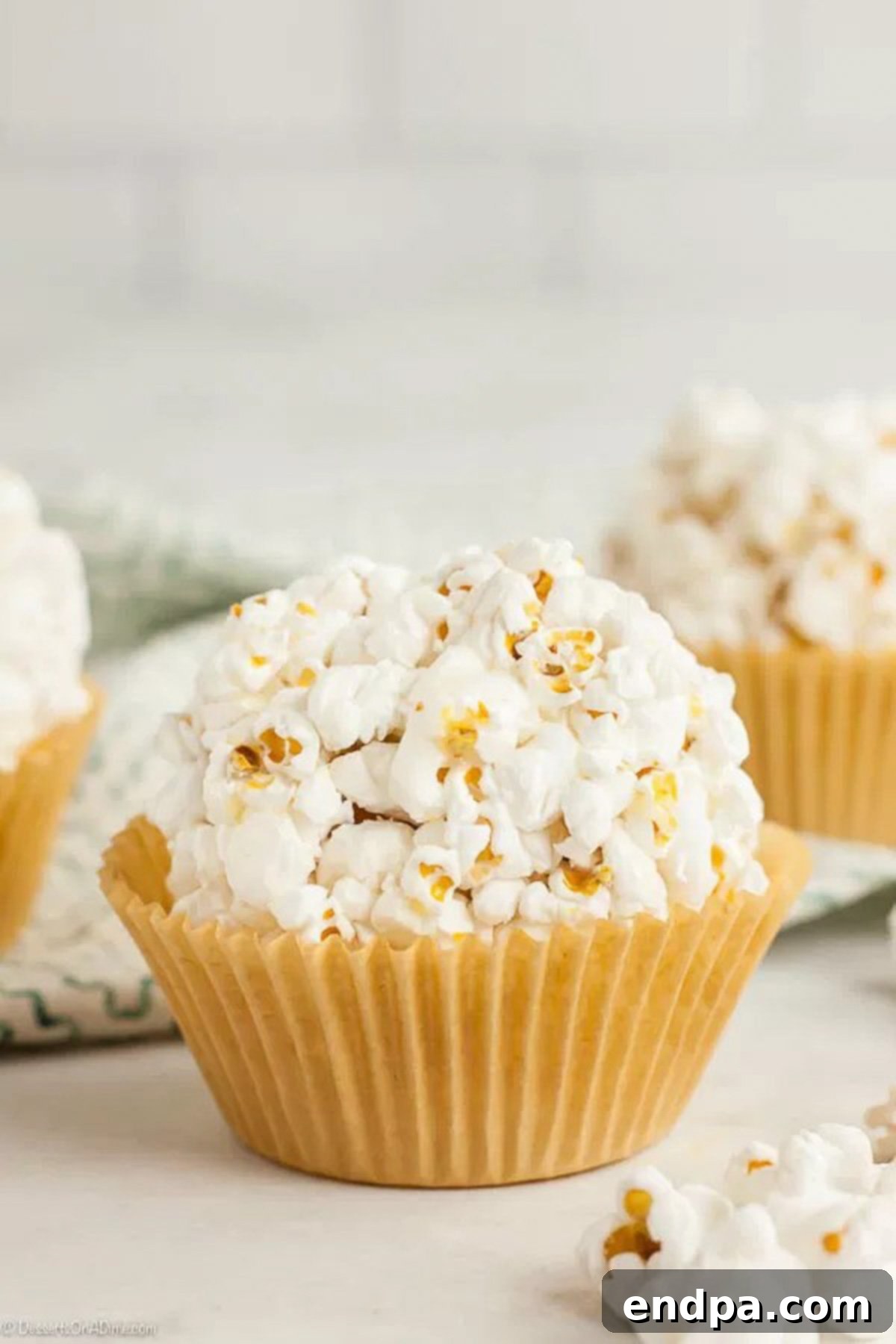 Close up of a popcorn ball with another popcorn ball behind it