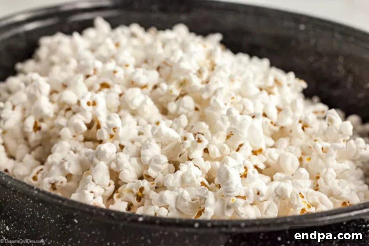 Popped popcorn in a large roasting pan.