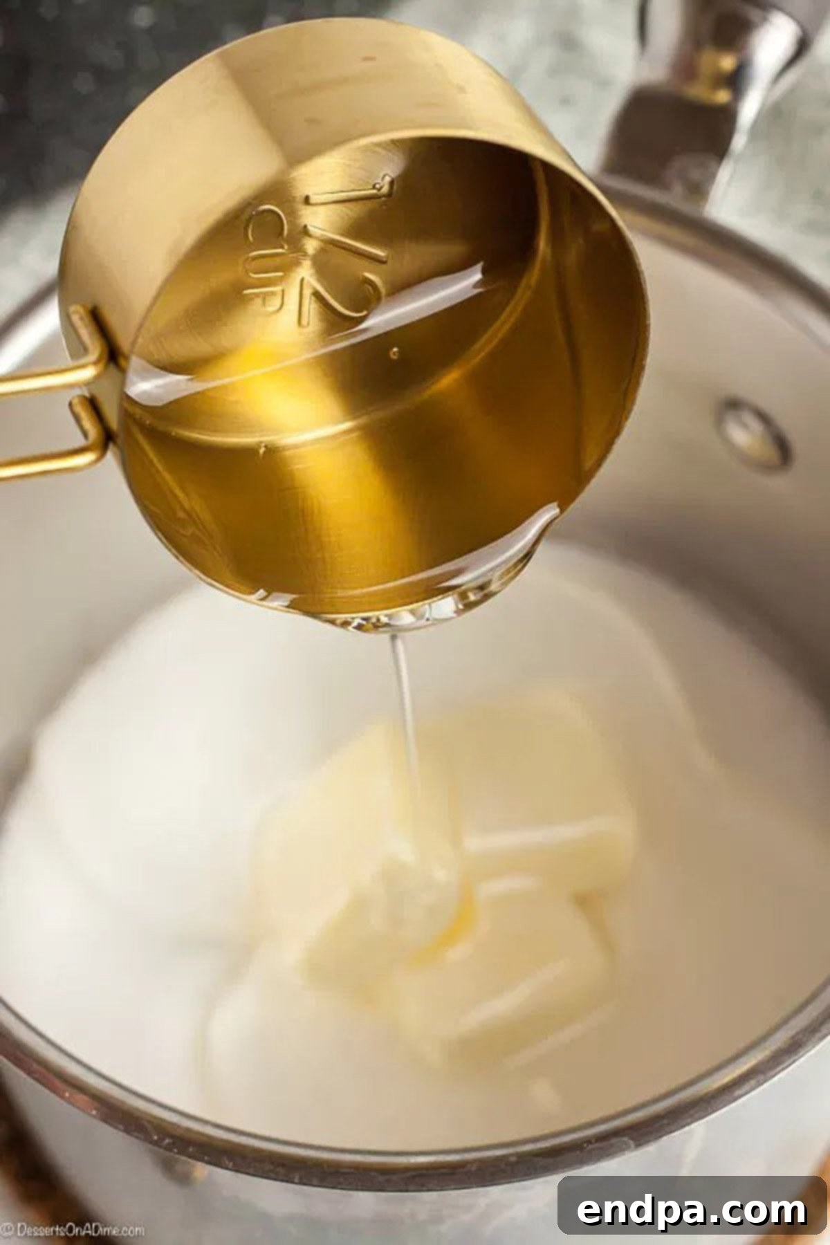 The corn syrup mixture being heated in a sauce pan on the stove top