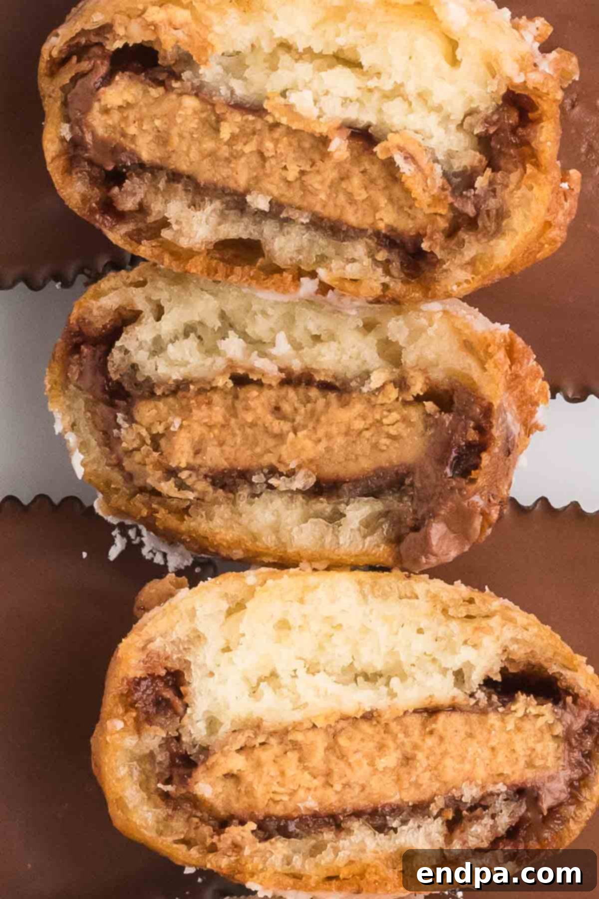 Deep fried reese's peanut butter cups stacked together and cut in half.