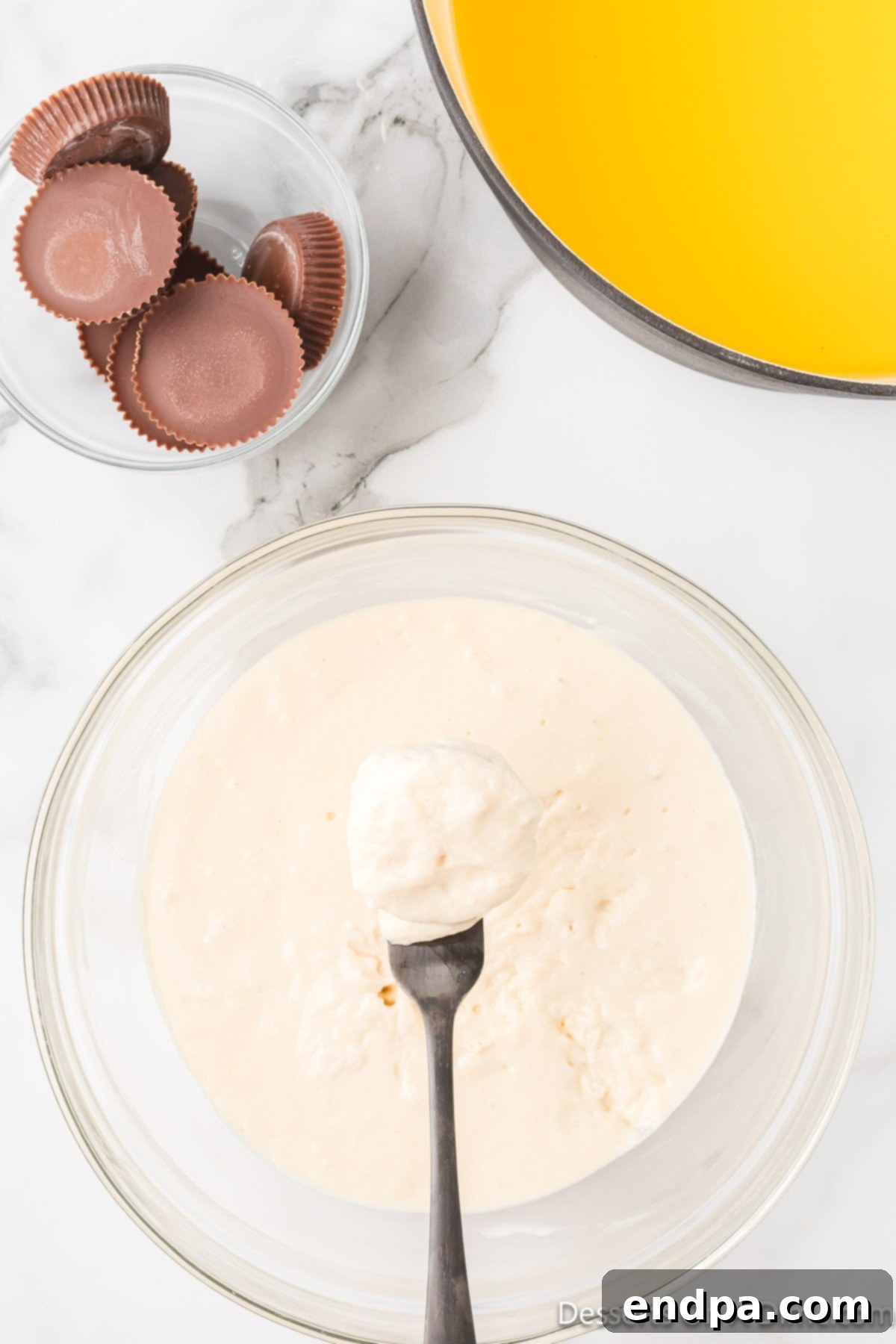 Reece's Cup dipped into the batter with a fork.