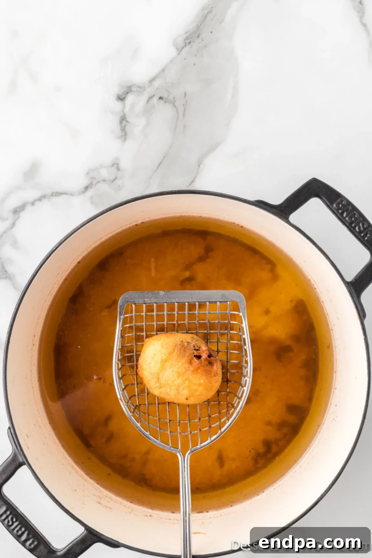 Reece's Cup fried and being removed from pan.